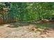Wooded backyard featuring mature trees and firepit at 3380 Canon Bay Dr, Cumming, GA 30041