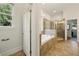 Elegant bathroom features a glass-enclosed shower, a soaking tub, and natural light from a nearby window at 3380 Canon Bay Dr, Cumming, GA 30041