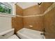 Bathroom featuring tiled walls and a shower over tub at 3380 Canon Bay Dr, Cumming, GA 30041
