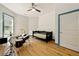 Bedroom featuring hardwood floors, a ceiling fan, and a large window at 3380 Canon Bay Dr, Cumming, GA 30041
