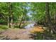 Picturesque creek amidst trees, showcasing the serene and natural surroundings of the property at 3380 Canon Bay Dr, Cumming, GA 30041