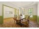 Dining room with brick floors, wainscoting, chandelier, and a wood table with upholstered chairs at 3380 Canon Bay Dr, Cumming, GA 30041