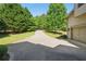 Long driveway leading to a home featuring mature trees, a well-kept lawn, and a two-car garage at 3380 Canon Bay Dr, Cumming, GA 30041