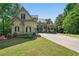 Charming two-story home featuring a well-manicured lawn, long driveway, and appealing architectural details at 3380 Canon Bay Dr, Cumming, GA 30041