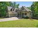 Beautiful home featuring a long driveway, manicured lawn, and an attached two-car garage at 3380 Canon Bay Dr, Cumming, GA 30041