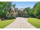 Attractive two-story home with a manicured lawn, driveway, and mature trees surrounding the property at 3380 Canon Bay Dr, Cumming, GA 30041