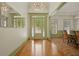 Bright foyer featuring hardwood floors, a decorative front door, and a modern chandelier at 3380 Canon Bay Dr, Cumming, GA 30041