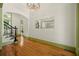 Stylish foyer featuring hardwood floors, decorative mirror, modern chandelier, and staircase at 3380 Canon Bay Dr, Cumming, GA 30041
