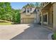 Attached two-car garage with an extensive driveway and charming rocking chairs on the front porch at 3380 Canon Bay Dr, Cumming, GA 30041