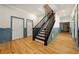 Hallway featuring hardwood floors, crown molding, and staircase at 3380 Canon Bay Dr, Cumming, GA 30041