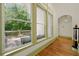 Bright living room featuring expansive windows offering a view to the outdoor patio with comfortable seating at 3380 Canon Bay Dr, Cumming, GA 30041
