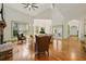 Bright, open living room with hardwood floors, fireplace, and large windows overlooking the yard at 3380 Canon Bay Dr, Cumming, GA 30041