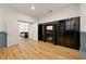 Bright living room featuring a fireplace and glass display cabinet with stylish hardwood floors at 3380 Canon Bay Dr, Cumming, GA 30041