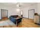Living room featuring hardwood floors and comfortable black leather sofas at 3380 Canon Bay Dr, Cumming, GA 30041