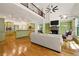 Open concept living space with a fireplace, built-ins, kitchen view, and hardwood floors at 3380 Canon Bay Dr, Cumming, GA 30041