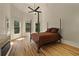 Spacious bedroom with high ceilings, a four-poster bed, and bright natural light from multiple windows at 3380 Canon Bay Dr, Cumming, GA 30041