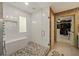 This luxurious walk-in shower is equipped with a shower bench, tiled walls, and pebble flooring at 3380 Canon Bay Dr, Cumming, GA 30041