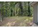 Tranquil backyard with mature trees and a dedicated area for an outdoor fire pit at 442 Cologne Se Dr, Atlanta, GA 30354