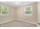 Well-lit bedroom featuring plush carpeting and two large windows for natural light at 442 Cologne Se Dr, Atlanta, GA 30354