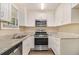Well-lit kitchen featuring stainless steel appliances, granite countertops and white cabinets at 442 Cologne Se Dr, Atlanta, GA 30354