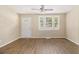 Bright living room featuring new hard wood floors, fan, and natural light from large windows at 442 Cologne Se Dr, Atlanta, GA 30354