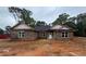 Charming single-story home with a stone facade, dark roof, and large windows at 5351 Tuscany Dr, Douglasville, GA 30135