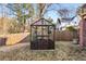 Beautiful backyard featuring a charming glass greenhouse and a well-maintained lawn at 1271 Fenway Cir, Decatur, GA 30030