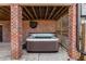 Backyard patio with a hot tub, brick columns, wood lattice, and privacy screen at 1271 Fenway Cir, Decatur, GA 30030