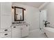 Bathroom with white cabinets, marble countertop, shower with glass doors and freestanding tub at 1271 Fenway Cir, Decatur, GA 30030