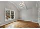 Charming bedroom with vaulted ceiling, chandelier, hardwood floors, and large window at 1271 Fenway Cir, Decatur, GA 30030