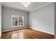 Cozy bedroom with hardwood floors, white trim, and a large window offering neighborhood views at 1271 Fenway Cir, Decatur, GA 30030