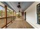 Spacious covered wooden deck with ceiling fans, railings, and access to backyard at 1271 Fenway Cir, Decatur, GA 30030
