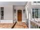 Charming entryway with a brick porch, beautiful wood door, and stylish lighting at 1271 Fenway Cir, Decatur, GA 30030