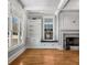 Spacious living room with built-in shelving, fireplace, hardwood floors, and window seats at 1271 Fenway Cir, Decatur, GA 30030