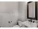 Powder room with pedestal sink, bronze fixtures and decorative mirror at 1271 Fenway Cir, Decatur, GA 30030