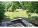 Expansive backyard with a stone patio, an outdoor grill area, and lush greenery, perfect for entertaining at 1676 Moores Mill Nw Rd, Atlanta, GA 30327