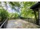 Stone tile balcony surrounded by mature trees providing lots of privacy and shade at 1676 Moores Mill Nw Rd, Atlanta, GA 30327