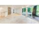 Open basement area with brick details, tile flooring, sliding glass doors, and natural light at 1676 Moores Mill Nw Rd, Atlanta, GA 30327