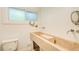 Modern bathroom featuring a unique stone sink, stylish fixtures, and a frosted window for privacy at 1676 Moores Mill Nw Rd, Atlanta, GA 30327