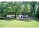 Beautiful home showcasing its spacious backyard, outdoor seating, and stone accents, perfect for relaxation and gatherings at 1676 Moores Mill Nw Rd, Atlanta, GA 30327