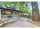Stylish exterior with stone and painted brick, complemented by an inviting entrance with benches at 1676 Moores Mill Nw Rd, Atlanta, GA 30327
