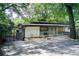 Charming single story home featuring gated entrance, modern design elements, and a beautifully landscaped front yard at 1676 Moores Mill Nw Rd, Atlanta, GA 30327