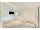 Spacious living room with light stone floors, natural light, and access to the outdoor patio at 1676 Moores Mill Nw Rd, Atlanta, GA 30327