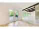 Open living space featuring exposed ceiling beams, stone accent wall, and access to a private balcony at 1676 Moores Mill Nw Rd, Atlanta, GA 30327