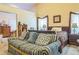 Comfortable bedroom with natural light, featuring a large bed and a cozy sofa at 2606 Fairmont Park Ct, Dacula, GA 30019