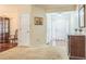 Bright foyer with hardwood and carpet floors and a view of the front door at 2606 Fairmont Park Ct, Dacula, GA 30019