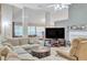 Spacious living room featuring high ceilings, large windows, and a modern entertainment center at 2606 Fairmont Park Ct, Dacula, GA 30019