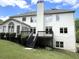 Back of the house with a wooden deck, well-kept lawn, and a combination of siding and brick finishes at 4091 Oberon Se Ct, Smyrna, GA 30080