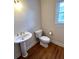 Powder room featuring pedestal sink, toilet, and window at 4091 Oberon Se Ct, Smyrna, GA 30080