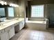 Bright bathroom with a double sink vanity, soaking tub, and separate shower at 4091 Oberon Se Ct, Smyrna, GA 30080